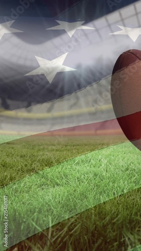 Waving american flag over multiple rugby balls falling against sports stadium in background