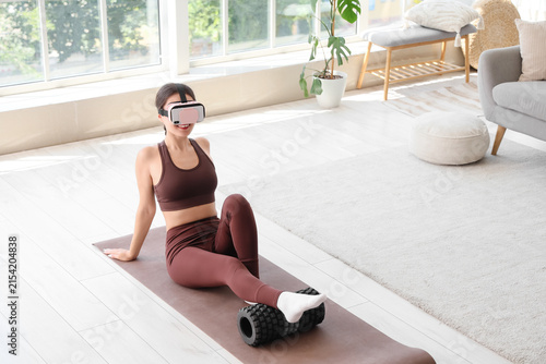 Sporty young woman in VR gl...