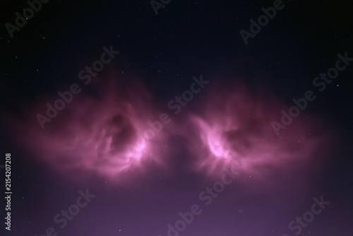The Purple Nebula Illuminates a Starry Night Sky with Soft Pink Glow