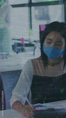 Animation of data processing over asian businesswoman with face mask using computer