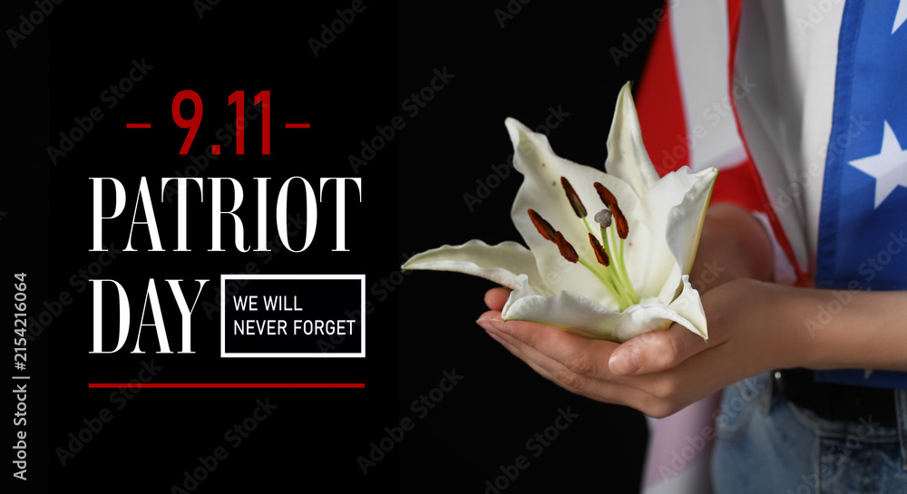 Obraz premium Patriot day 9.11 remembrance with a white lily in a hand and american flag, we will never forget