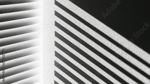 Sunlit wall with parallel light and shadow stripes from window blinds