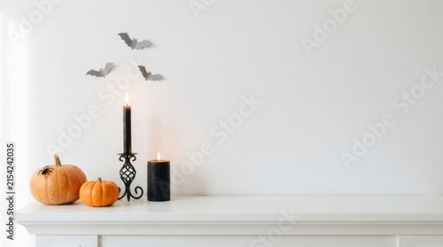 Minimalist white mantelpiece with Halloween candle and bats