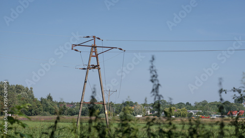 ENERGETICS - Medium voltage line over green pastures and meadows