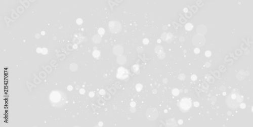 Glowing white dust and glitter particles on a transparent background. Magical sparkle effect for Christmas celebrations, cards, posters, and invitations.
