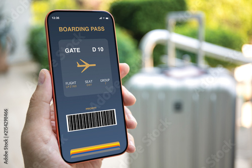 Man hand holding phone with digital boarding pass airport luggage