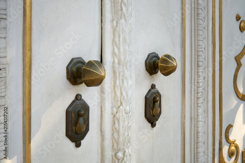 Canvas Print Close-up of the ornamental door bronze handles is located in the door