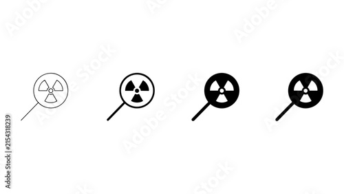 Photography Set of four radiation hazard symbols inside magnifying glass isolated on a white