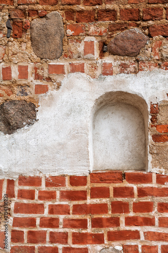 Weathered brick wall with stone masonry