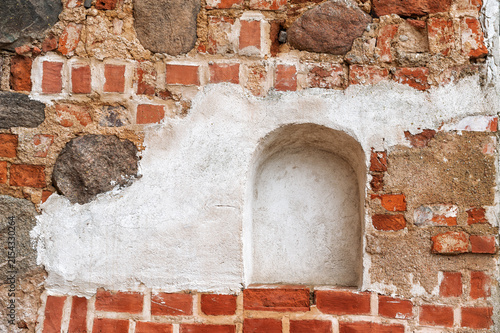 Weathered brick wall with stone masonry