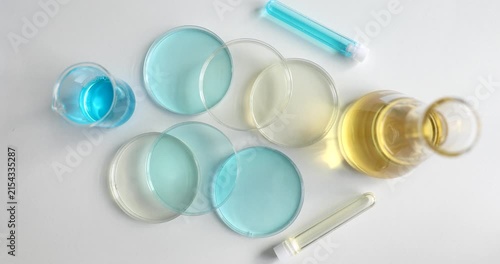 Colorful liquids in various glass containers create an artistic arrangement. The play of light on the glass creates beautiful reflections, showcasing creativity and design.