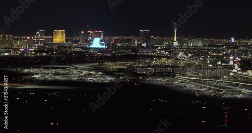 Las Vegas Nevada Aerial v116 telephoto night flyover across airport runways toward the Strip, Sphere, High Roller and downtown lights - Shot with Mavic 3 Pro Cine - May 1st 2024