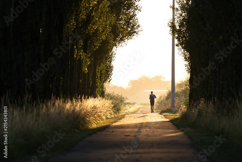 A man running in the countryside on a nice, summers moring in the Netherlands.