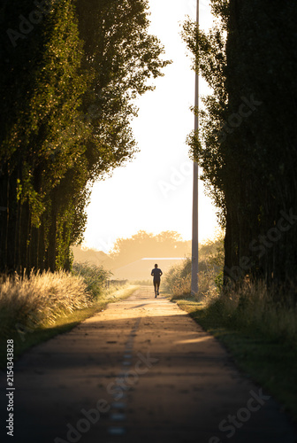 A man running in the countryside on a nice, summers moring in the Netherlands.