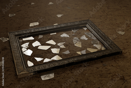 3d rendering of vintage picture frame with scattered glass shards laying on sandy soil