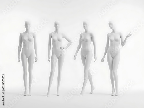Four white female mannequins standing in a bright studio display