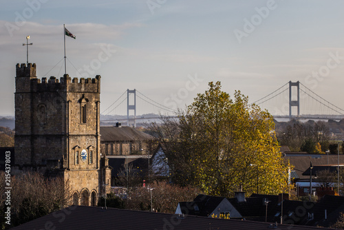 Fotografía St Mary's Priory Church Tower with Distant Severn Bridge in Chepstow Monmouthshi