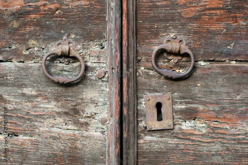 old weathered wooden door with knockers