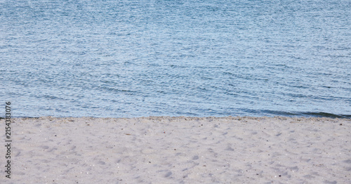 Photography Sandy beach coastline with calm blue sea water surface banner background