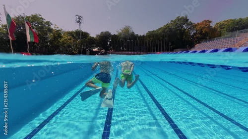 Split View Two Boys Swimming Underwater in Outdoor Pool