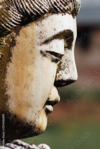 side view of an antique Buddha statue