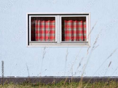 small windows with checked curtains