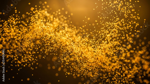 Abstract background of golden dust particles floating in light with particles background abstract floating movement contrast atmosphere celebration