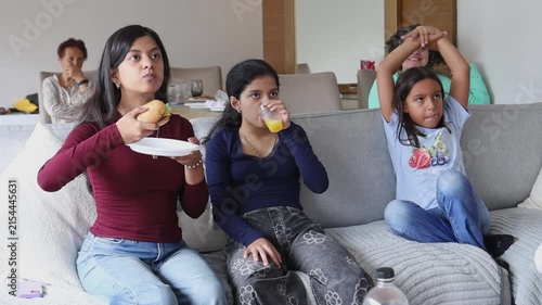 Multigenerational Family Laughing Together on Sofa at Home