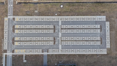 Aerial view of the Severna Zona parking lot with clearly marked parking spaces, asphalt lanes, and pedestrian crossings in Pancevo, Serbia.