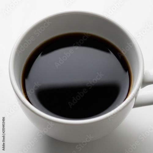 A close-up view of a mug filled with dark liquid