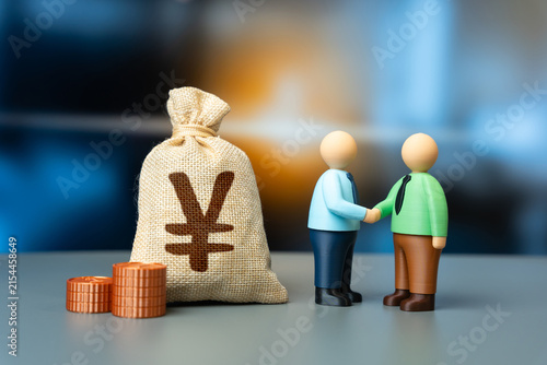 Fotografie Businessman shaking hands and Yen or yuan money bag