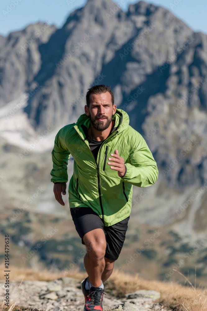 Fototapeta premium Male athlete trail running on mountain path