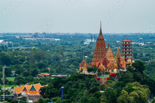 Landscape of Wat Tham Sua Temple (Tiger Cave Temple) in Sunset scence with Jasmine rice fields at Kanchanaburi Province, Thailand. Is an important landmark that everyone must visit