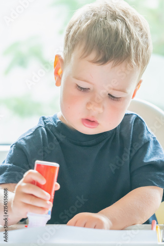 Young child discovering the joy of art through spontaneous creative play.