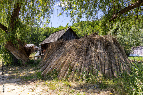 Konstfotografi Thatched Roof Cottage and Dried Reed Bundles