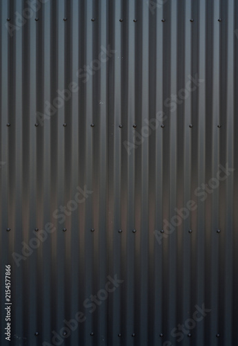 Obraz na plátně Vertical close up of black corrugated industrial tin siding with uniform vertica