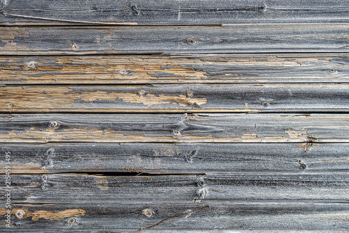 Weathered vertical wooden fence boards with natural wood grain, knots and aged rustic texture.