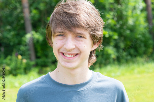  Happy teenage boy smiling at camera in summer nature forest