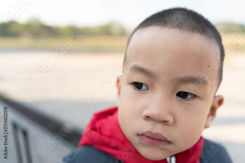 Thoughtful child outdoor setting portrait photography natural light close-up exploring emotions