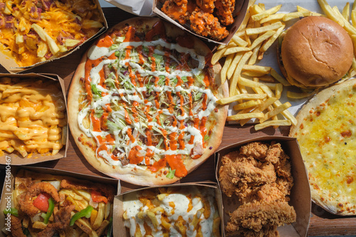 Doner kebab pizza with fried chicken, burger, loaded fries and fast food sides