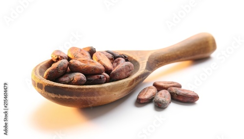 rustic wooden spoon with cocoa beans