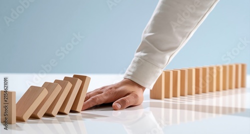 Domino effect stopping by hand for business risk management and crisis intervention
