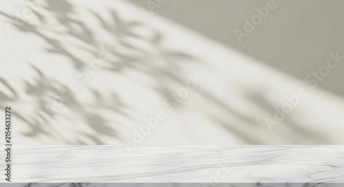Empty Marble Table Surface with Soft Leaf Shadows on a Light Beige Wall Background for Product Display Presentation