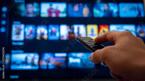 Canvastavla Person browsing a streaming menu with a remote control