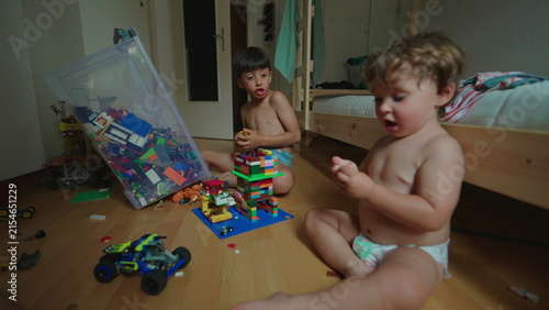 Quadro su tela Toddler throwing toys toward older sibling in bedroom at home, provocative behav
