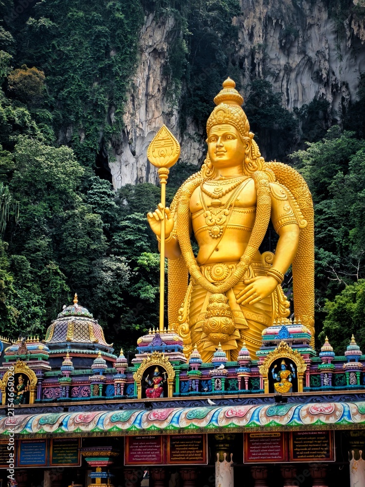 Batu Caves, Kuala Lumpur, Malaysia, is distinguished by the gold-plated statue of Lord Murugan and 272 rainbow-colored steps leading to the sacred Hindu cave.