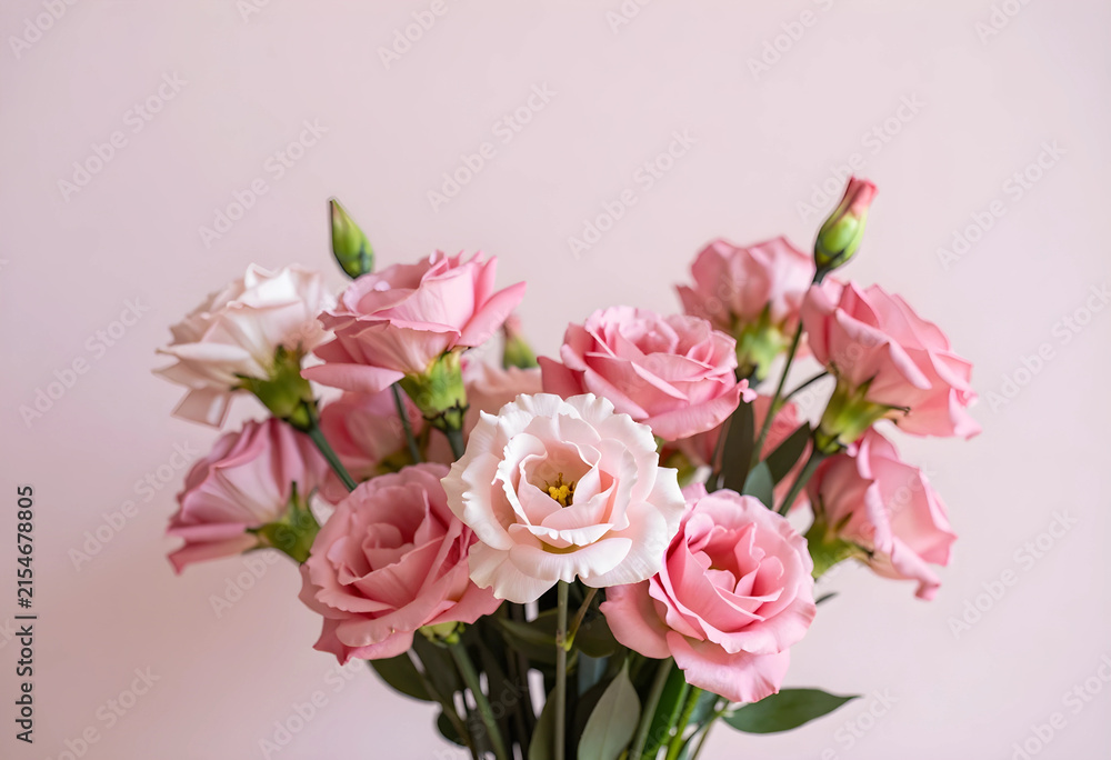 Fototapeta premium Pink eustoma flowers bouquet with delicate petals and green stems against a soft pastel background, elegant floral arrangement