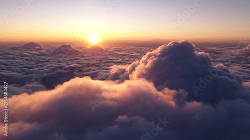 Sunrise over vast cloudscape with golden light and soft hues