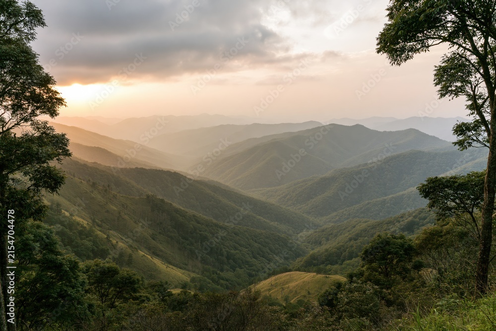 Obraz premium The Mountain Landscape Serene Valley Ridges Under Golden Sunset Light