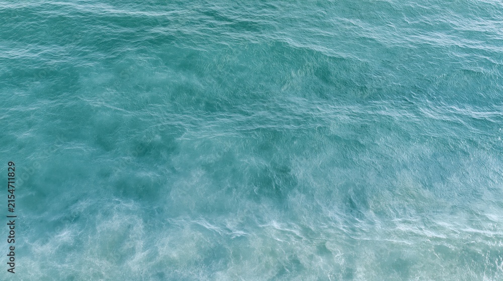 Fototapeta premium The Ocean Turquoise Waves along the Shore With Foamy White Surf